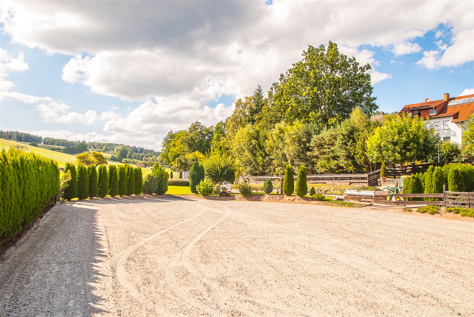 Der Reit/Springplatz ist durch eine Hecke geschützt, um Winde zu vermeiden und damit die Pferde nicht gestört werden - Oliver Reifferscheid - Immobilienmakler Darmstadt